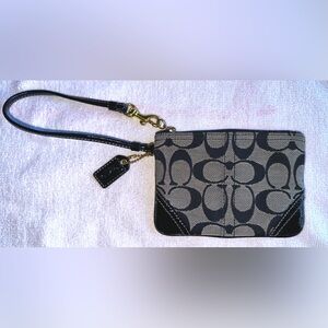 Coach signature black and gray zip wristlet with gold accents and black leather